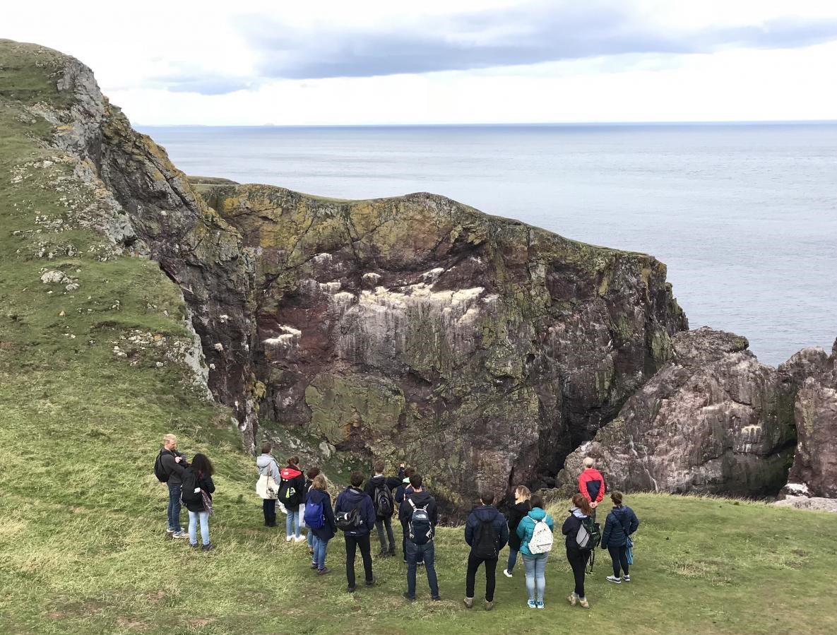 Image of masters students by the shoreline.