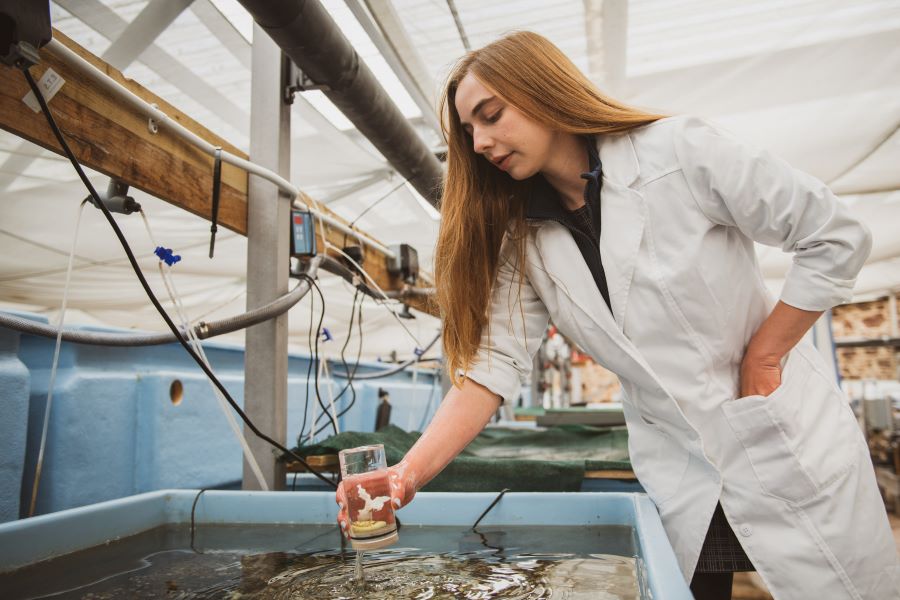 Kelsey Archer Barnhill at St Abbs Marine Station with coral sample 