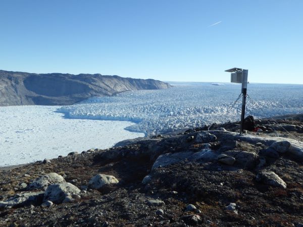 Scientific equipment on ice-covered shoreline.